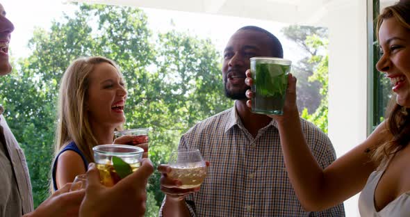 Group of friends toasting drink glasses