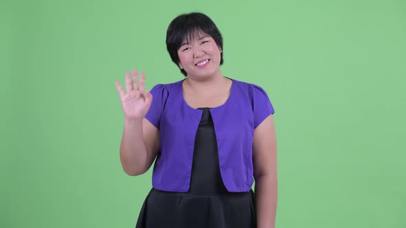 Happy Young Beautiful Overweight Asian Woman Waving Hand