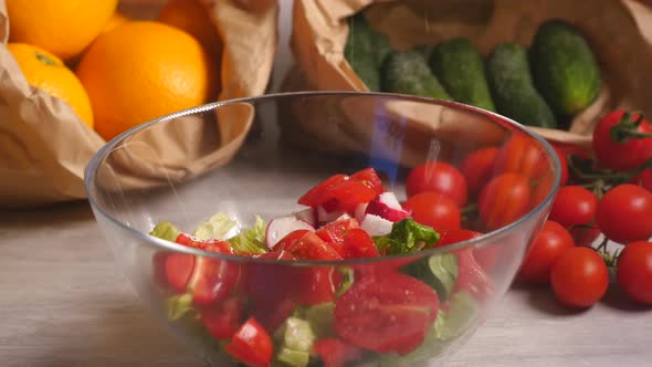 Preparing Vegetable Salad of Tomatoes, Cucumber, Lettuce and Radish 