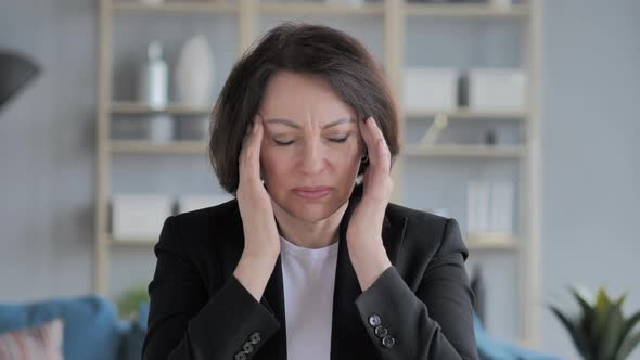 Portrait of Old Businesswoman Gesturing Headache, Stress