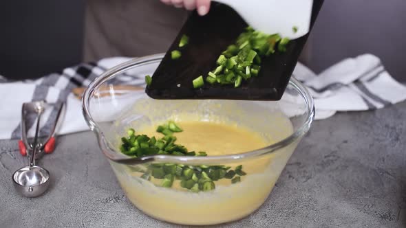 Step by step. Mixing ingredients together in glass mixing bowl for spicy jalapeno cornbread muffins.