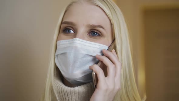 Closeup Portrait of Young Girl in Medical Face Mask Is Talking at Phone