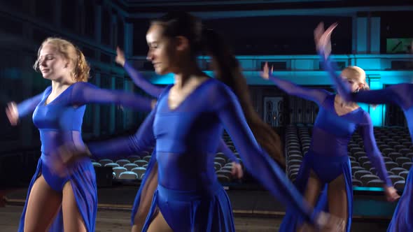 Group Young Skillful Ballerinas Dancing Modern Ballet on the Stage of Large Hall. Girls Looking at