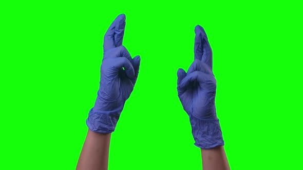 Doctors Female Hands in Blue Gloves with Fingers Crossed, Pending