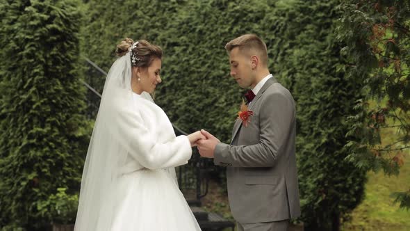 Lovely Newlyweds Caucasian Bride Embracing Groom in Park Making Kiss Wedding Couple Family Hugging