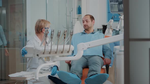 Stomatologist Doing Dental Examination with Orthodontic Tools