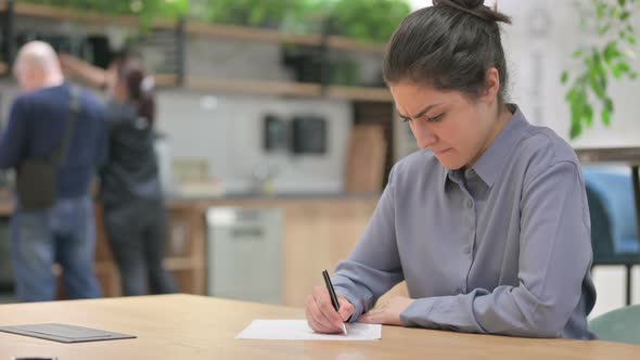 Young Indian Woman Having Failure at Writing on Paper