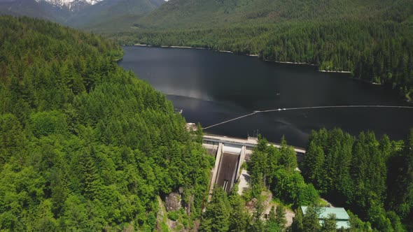 Aerial view flying toward the Cleveland Dam and Capilano Lake in North Vancouver, British Columbia.