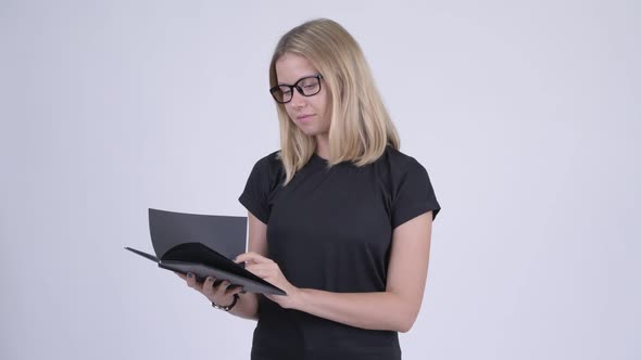 Young Shy Blonde Nerd Woman Covering Face with Book