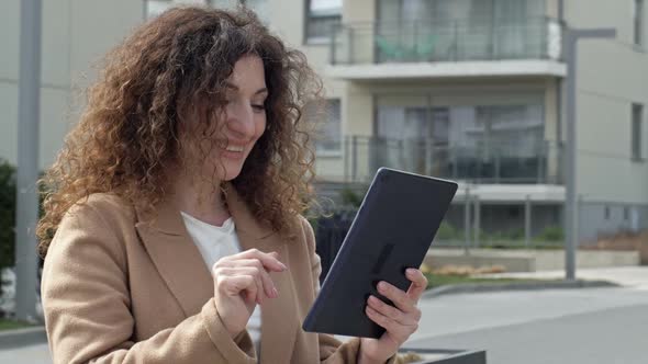 Curlyhaired Woman Middleaged Walks Along a Deserted City Street