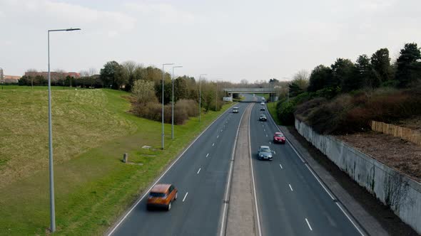 The highway full of cars passing true.