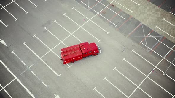 Vintage red vehicle, old fire engine equipped with tools for firefighting tasks, driving on empty pa