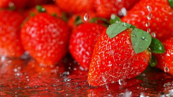 Super Slow Motion Shot of Water Splashing on Fresh Strawberries at 1000Fps