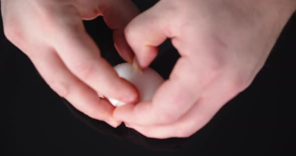 Men's Hands Smash the Shell of Raw Eggs.