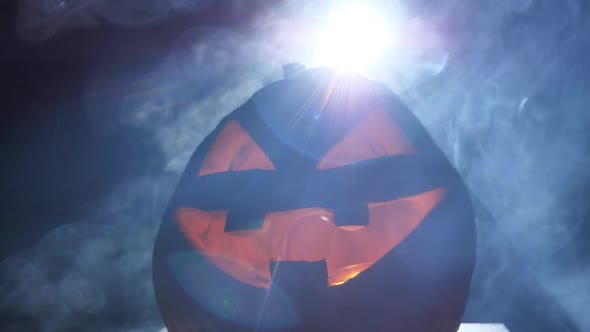 Smiling Halloween Pumpkin and Scary Eyes for a Party Surrounded By Smoke