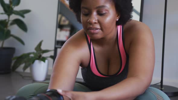 African american female plus size vlogger recording a video about working out