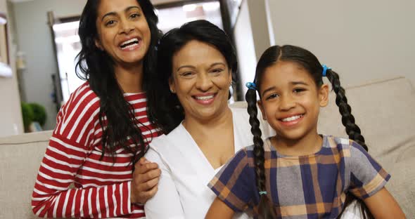 Multi-generation family sitting together in living room 4k