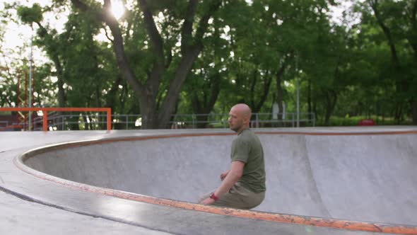 Skateboarder Doing a Tricks in a Concrete Skate Park