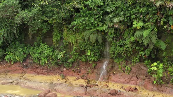 Slow turning around a small waterfall in a tropical rainforest in South America 