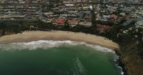 Aerial of secluded beach in Laguna Beach, CA. camera dollies to left.