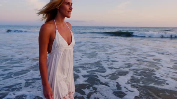 Attractive Woman Enjoying The Beach At Sunset