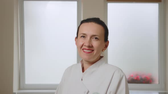 Happy Young European Woman Doctor Wearing White Medical Coat and Stethoscope