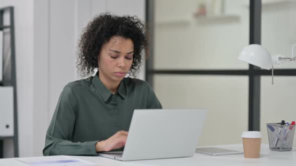 African Woman Having Neck Pain While Using Laptop