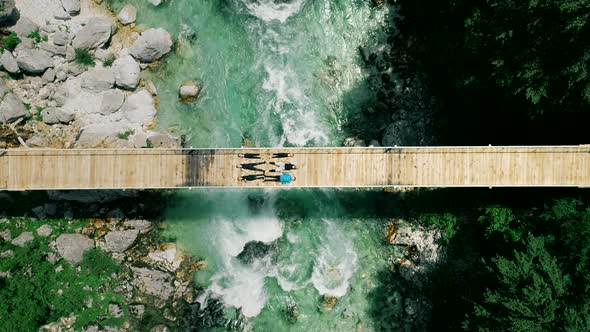 Aerial view of people lying on bridge over Soca river in Slovenia.