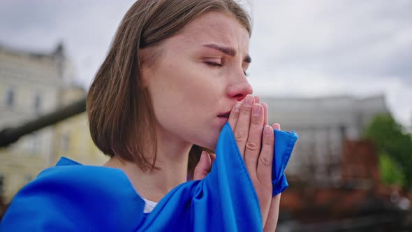 Ukrainian Woman Prays for Peace Feeling Pain for Homeland