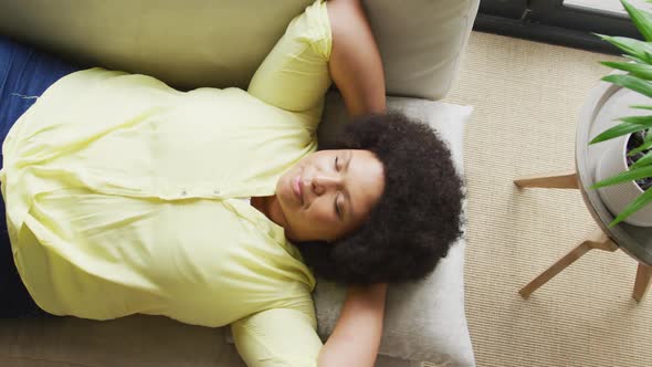 Video of plus size african american woman relaxing on sofa