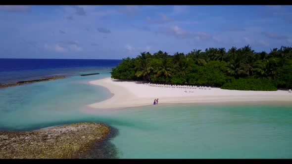 Aerial top view scenery of beautiful tourist beach break by blue sea and clean sand background of a 