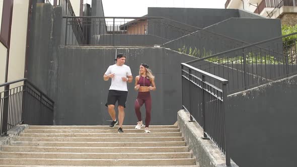 Couple Running on Stairs in Morning, Jogging in Urban Area with Starecases.