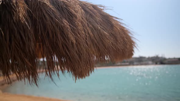 A straw umbrella on a beautiful beach