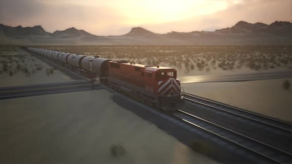 Fast locomotive train passing a railway crossing on a desert landscape. 4KHD