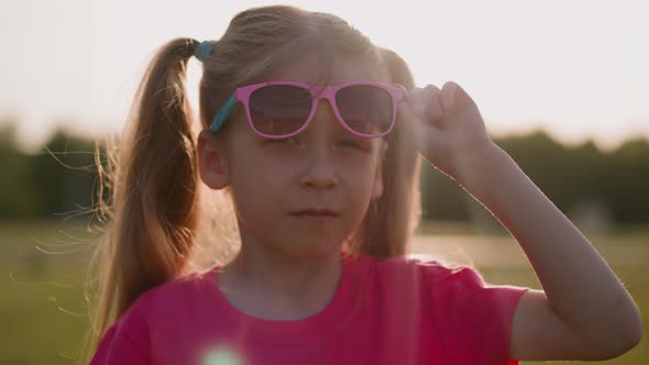 Upset Little Girl Takes Off Sunglasses to Show Injured Eye