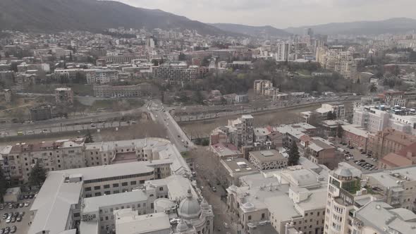 Aerial View of Galaktion Tabidze Bridge over Kura river in the centre of Tbilisi. Georgia 2021 April