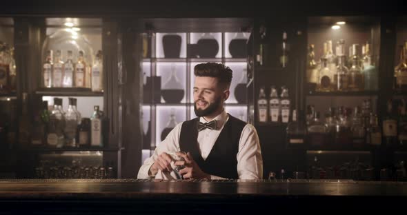 The Bartender Is Wiping the Glass with a Towel. 