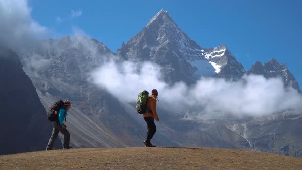 Hikers Travel in the Himalayan Mountains