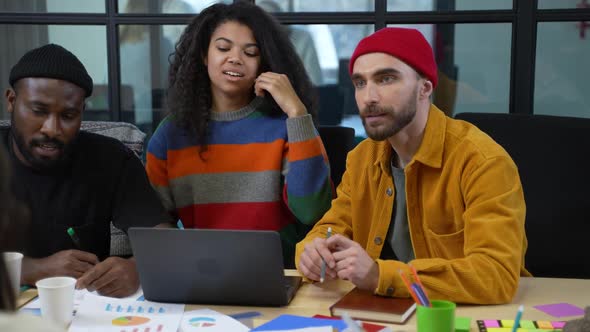 Group of Diverse Colleagues Working at Laptop