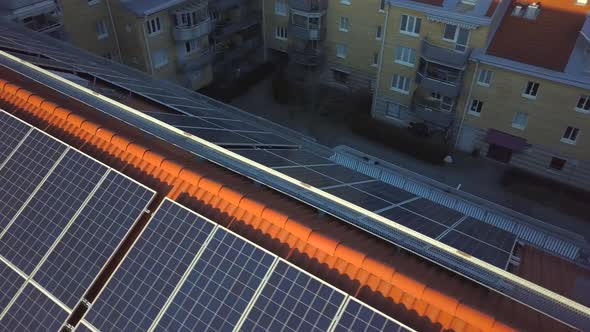 Solar power panels on top of residential building roof for producing of green ecological electricity