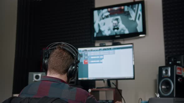 A Man Sound Engineer Watching the Rapper Whlie Recording His Track