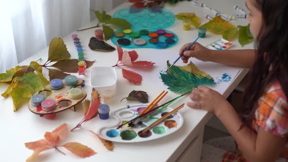 Little Girl Painting on Autumn Yellow Leaves with Gouache Kids Arts Children Creativity Autumn Art