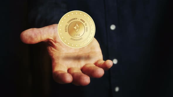 Ethereum ETH cryptocurrency golden 3d coin over hand