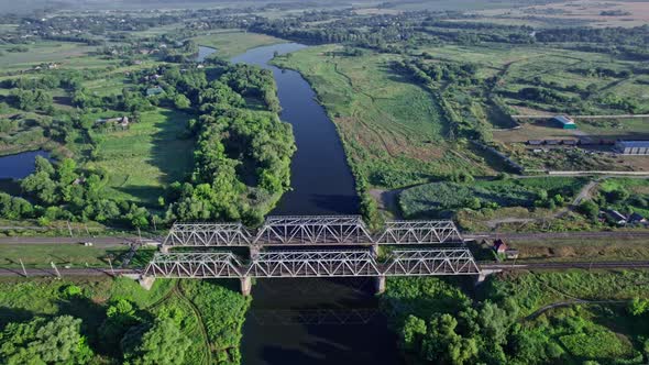 Train Bridge Crossing a River on a Bright Day