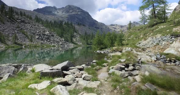 Forward Pov Walking Along Trail Looking at Clear Blue Lake