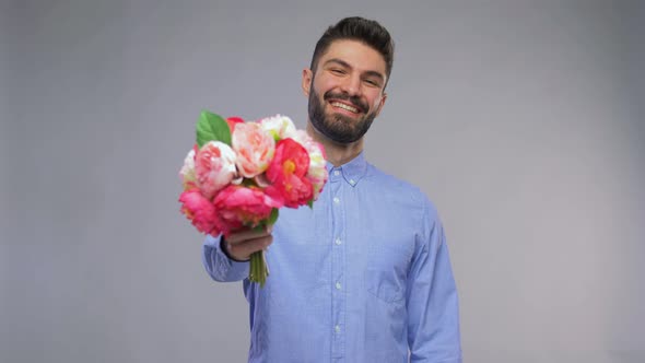 Happy Smiling Young Man with Bunch of Flowers