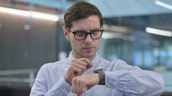 Portrait of Young Man Using Smart Watch