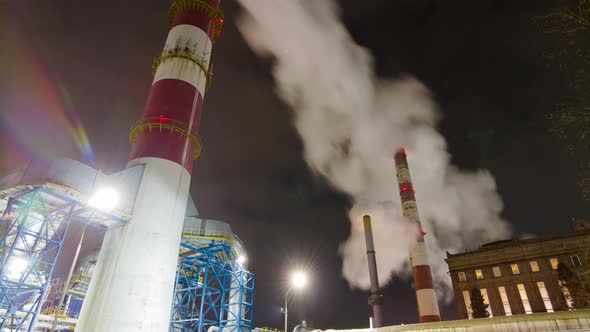Large chimneys smoke in a large enterprise, tilt time-lapse