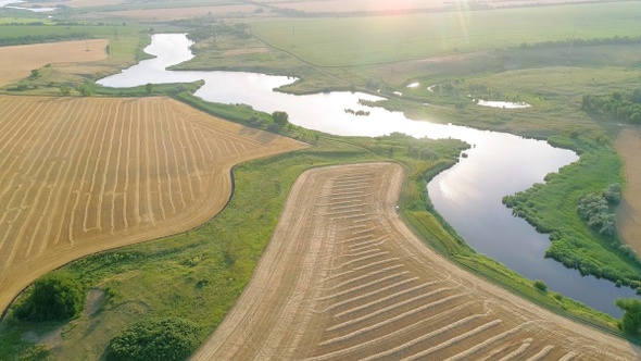 Scenic aerial view of winding river and agricultural fields