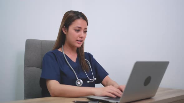 Beautiful doctor woman use laptop to consulting for patient via online meeting